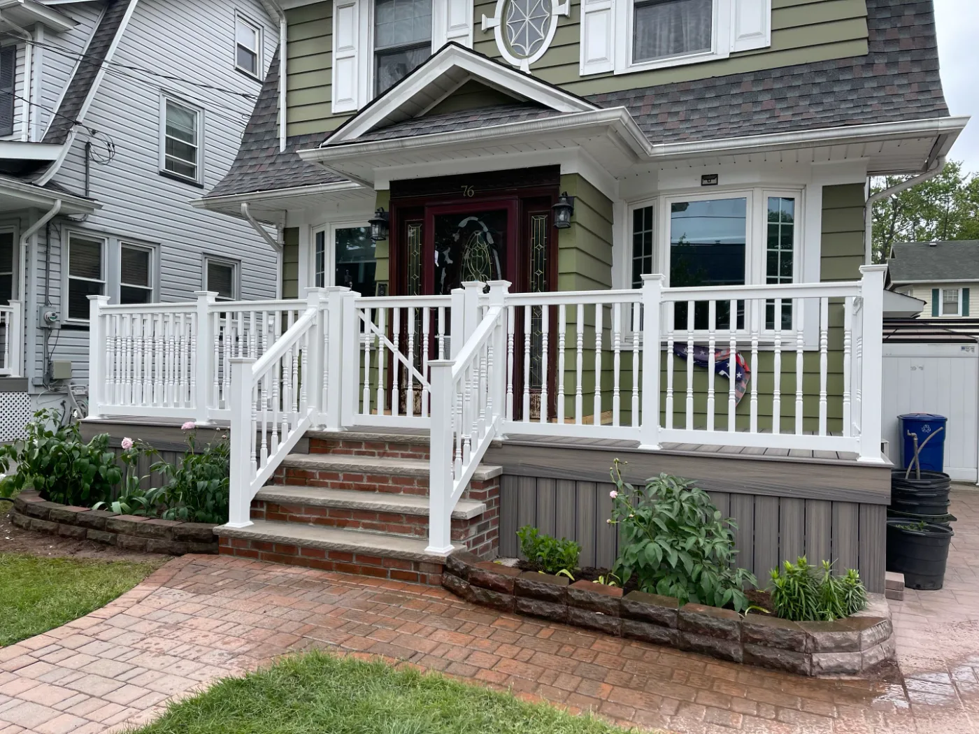 After: rebuilt front porch with white railing